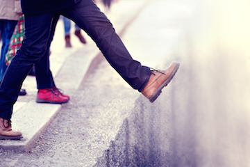 Image of man stepping off curve above hole