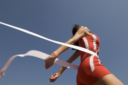 Image of Female Athlete Crossing Finish Line