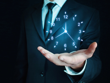 Image of a man holding a clock in his hand