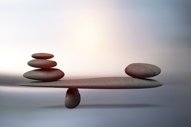 Image of rocks balancing on two sides of a plane