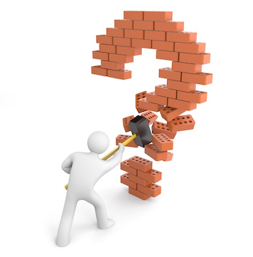 Image of a man breaking through a question mark made of bricks