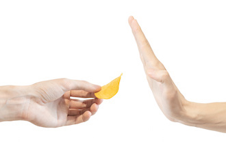 Image of hand held up to decline a potato chip