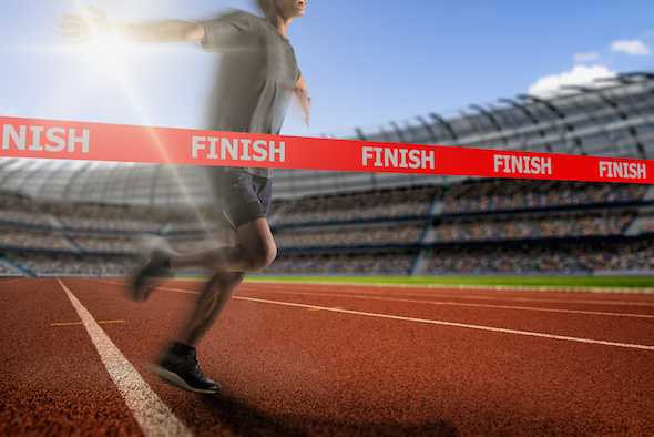 Image of runner crossing finish line