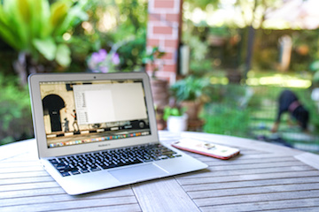 Image of laptop on picnic table in backyard