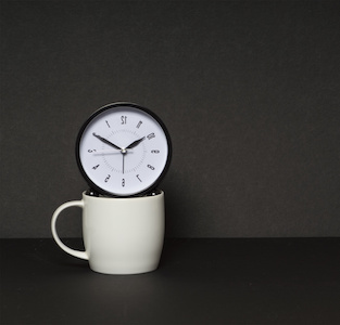 Image of a clock floating over a coffee cup