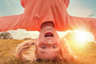 Image of young girl standing on her head