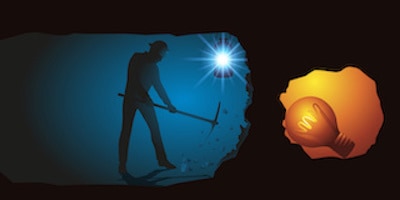 Man in underground tunnel digging with pickaxe towards a lightbulb in a small cave