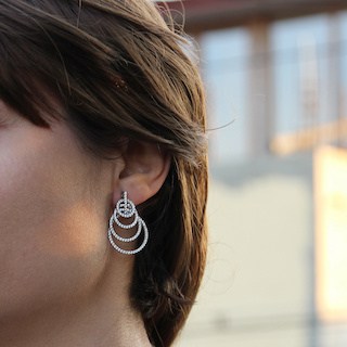 Image of close up of beautiful woman wearing a shiny hooped earring