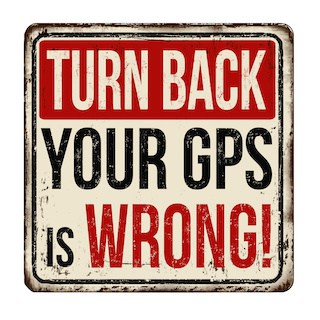 Image of vintage rusty metal road sign that says Turn Back Your GPS Is Wrong! in all capital letters