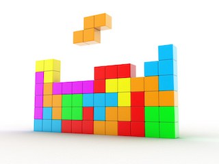 Image of wall of multi-colored Tetris blocks with a stair-shaped set of four blocks hovering above