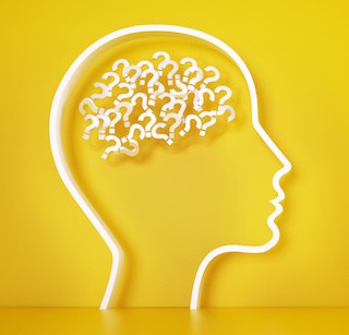 image of outline of a big head in profile with white question marks inside brain all on a gold background.