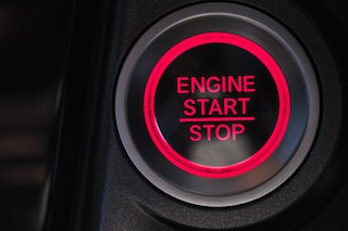 Image of a car engine button with the words in red "Engine Start | Stop"